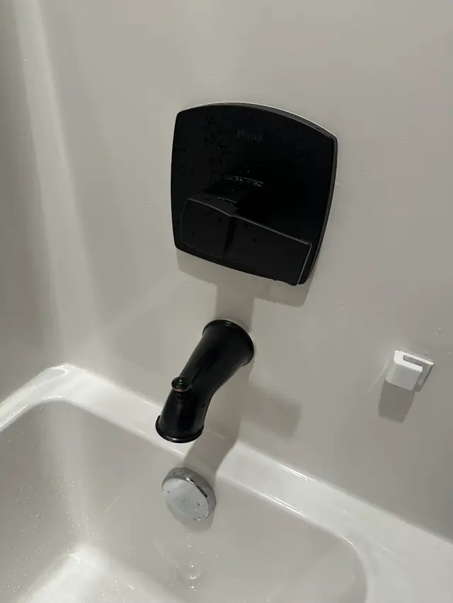 Matte-black tub spout and valve trim on a white tub, the kind of fixture installation CSR does in Yakima homes