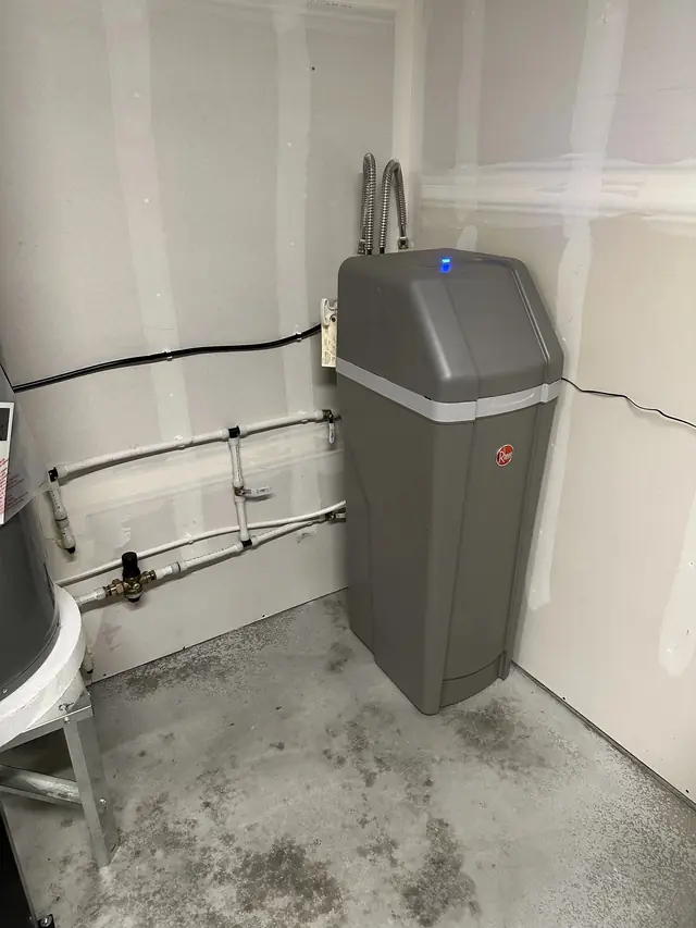 A new water softener plumbed into a utility room by CSR Plumbing
